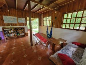 a living room with a bench and a table at Corcovado Guest House in Drake