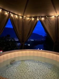 a jacuzzi tub with a view of the city at The Tiny home avec jacuzzi 5 min du lac du Bourget 10 min d Aix les bains et Chambery in Voglans