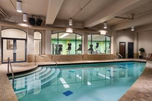 a swimming pool with blue water in a building at Holiday Inn & Suites North Vancouver, an IHG Hotel in North Vancouver