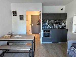 a living room with a table and a kitchen at pin rollan beach in Saint-Mandrier-sur-Mer +15 photos