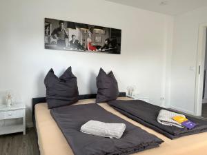 a bedroom with a large bed with black sheets and pillows at Domo Dolce Wohnapartment 