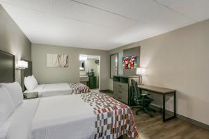 a hotel room with two beds and a desk at Red Roof Inn Baltimore in Baltimore +28 photos