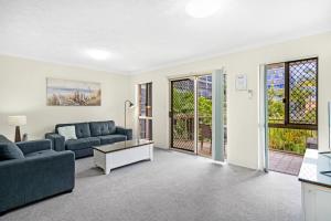 a living room with a couch and a table at Oceanside Cove in Gold Coast