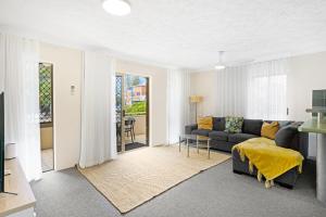 a living room with a couch and a table at Oceanside Cove in Gold Coast