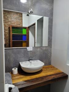 a bathroom with a sink and a mirror at Casa San Martin Suites in Cochabamba