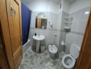 a bathroom with a toilet and a sink at Terrazas del Sur in Los Abrigos