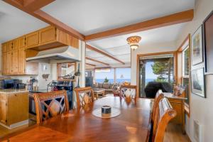a kitchen and living room with a table and chairs at Whale Vista in Depoe Bay