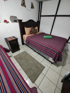 1 dormitorio con cama y alfombra en el suelo en Francisco's rest house hotel en Antigua Guatemala