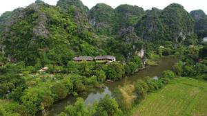 an aerial view of a river and a mountain at Trang An Ecolodge in Ninh Binh