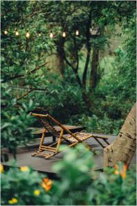 a wooden bench sitting on top of a wooden deck at Trang An Ecolodge in Ninh Binh