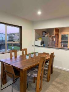 a wooden table and chairs in a kitchen at Tranquil Retreat - Spacious Home for a Relaxing Getaway 