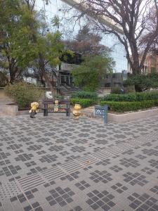 a group of teddy bears sitting around a park bench at Casa Huarpes in Mendoza