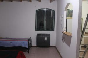 a room with a room with a window and a bed at Casa Huarpes in Mendoza
