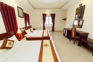 Postel nebo postele na pokoji v ubytování An Phu Hotel Da Lat