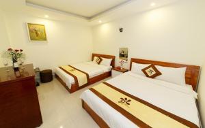 Postel nebo postele na pokoji v ubytování An Phu Hotel Da Lat