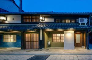 a building with doors and windows at night at Hitoiki in Nagahama