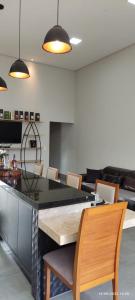 a dining room with a table and chairs at Residência Cidade Verde 3 in Maringá