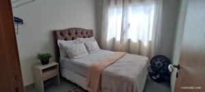 a bedroom with a bed and a window at Residência Cidade Verde 3 in Maringá +10 photos