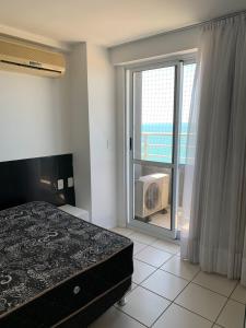 1 dormitorio con cama y vistas al océano en Appartement Duplex, en Fortaleza