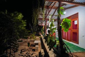 a house with a red door and some plants at Serene Cottage Ella in Ella