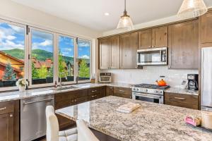 a kitchen with wooden cabinets and a granite counter top at Mountain Vista Retreat in Steamboat Springs