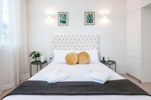 a white bedroom with a large white bed with two side tables at 'Executive Luxury Retreat' Eco Passive Living in Sydney