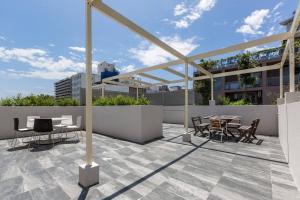 a patio with a table and chairs on a building at Urban Oasis Custom Made for Cosmopolitan Living in Sydney