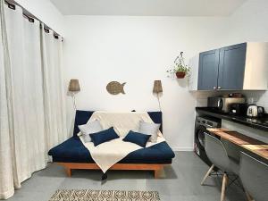 a living room with a blue couch with pillows at Apartamento praia de Copacabana in Rio de Janeiro