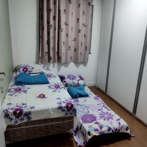 a bedroom with two beds and a window at Apartamento em Teresópolis - RJ in Teresópolis