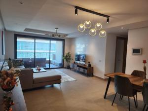 a living room with a couch and a table at Appartement de luxe Marina Casablanca in Casablanca