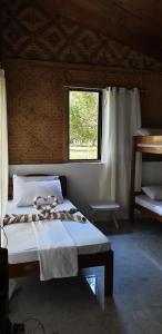 a bedroom with a large bed with a window at The Beach House at Dipnay San Fernando, El Nido in El Nido