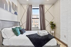 a bedroom with a large bed and a window at SWJ Btm G, 1 and 2 - Save on 2Day+ Stays_6Br Triplex in New York