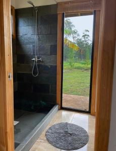 a bathroom with a shower and a glass door at Taina Ta in Hanga Roa