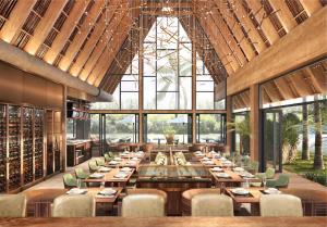 a restaurant with wooden tables and chairs and large windows at Armin Homes Ecopark Red Riverview Sky Oasis in Kim Quan