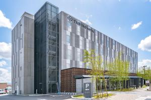 an office building with a parking meter in front of it at TABINO HOTEL Sado in Sado