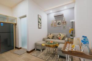 a living room with a couch and a table at Sunnydays homestay in Jepara