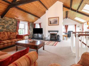 a living room with a couch and a table at Coombe Cottage in Borrowdale