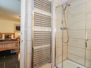 a shower with a glass door in a bathroom at Coombe Cottage in Borrowdale Valley +38 photos