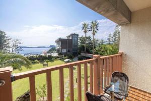 a balcony with a view of the ocean at The Bay Jeju Resort in Seogwipo