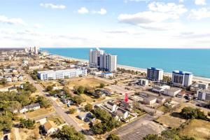 an aerial view of a city and the ocean at ﻿Charming Centrally Located Ocean View w Huge Private Yard, Patio, Firepit, & BBQ in Myrtle Beach +65 photos