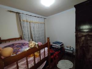 a bedroom with a bed and a window at Casa amarela 1 quarto in Cabo Frio