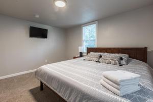 a bedroom with a large bed with a tv on the wall at Kansas City Riverside Retreat in Kansas City
