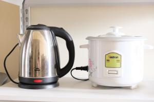 a tea kettle and a toaster on a counter at Spacious 1BR Corner Unit in IT Park in Cebu City