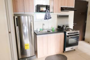 a kitchen with a stainless steel refrigerator and a sink at Spacious 1BR Corner Unit in IT Park in Cebu City +13 photos