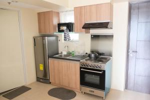 a small kitchen with a stove and a sink at Spacious 1BR Corner Unit in IT Park in Cebu City