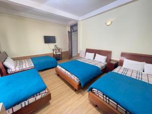 Postel nebo postele na pokoji v ubytování Hân Hoan Hotel