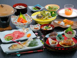 a table with many plates of food on it at Ashinomaki Prince Hotel in Aizuwakamatsu