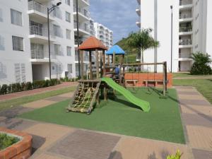 un parque infantil con un tobogán y un tobogán en Espléndido y Fantástico Apartamento en Girardot. 4 Piscinas, WiFi, Parque infantil, Parqueadero privado. en Girardot