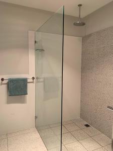 a shower with a glass door in a bathroom at 21 On Court in Mudgee