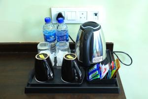 a tray with two bottles of water and two cups at Country Inn & Suites By Umrb - Mumbai International Airport in Mumbai
